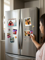 Person placing a photo magnet on a Samsung refrigerator.