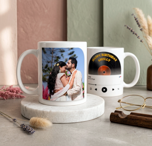 Two photo mugs on a surface with one featuring a couple and the other a vinyl record design.