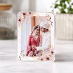 Acrylic Photo Frame Fridge Magnet with a couple in traditional attire and floral design on a light background