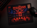 A rectangular gaming mousepad with a dark, fiery horror-style graphic reading 'The Upside Down' and 'Hawkins 1983,' shown on a dark desk alongside a black computer mouse and part of a keyboard.