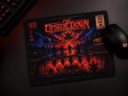 A rectangular gaming mousepad with a dark, fiery horror-style graphic reading 'The Upside Down' and 'Hawkins 1983,' shown on a dark desk alongside a black computer mouse and part of a keyboard.