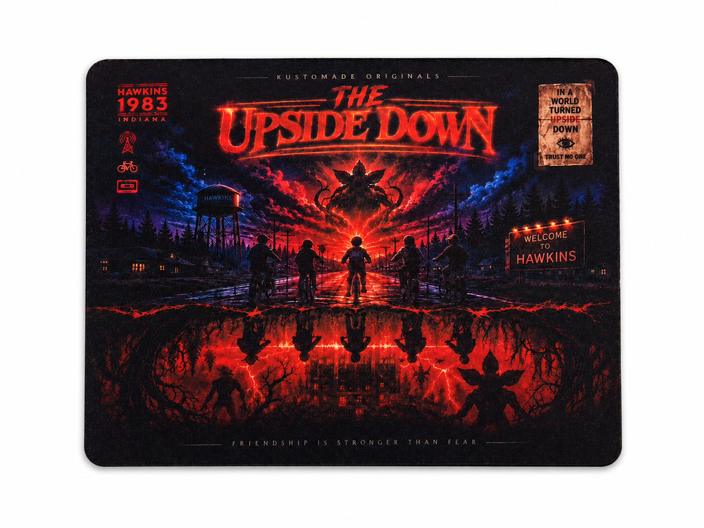 A rectangular custom gaming mouse pad with rounded corners, featuring a dark horror-themed graphic design titled 'THE UPSIDE DOWN' in glowing red-orange text. The artwork depicts silhouetted figures standing in a reflective puddle of red and black liquid, with a haunted house in the background and 'HAWKINS 1983' printed on the left side.